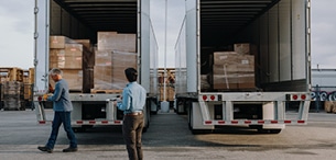 two men unloading trucks