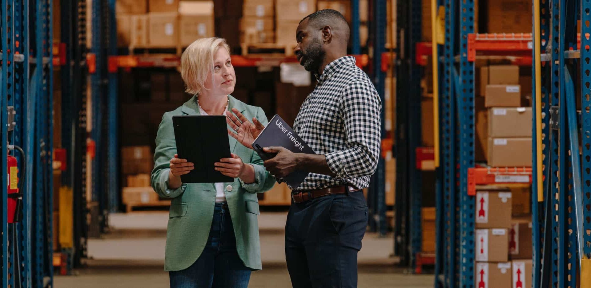 two people discussing something in warehouse